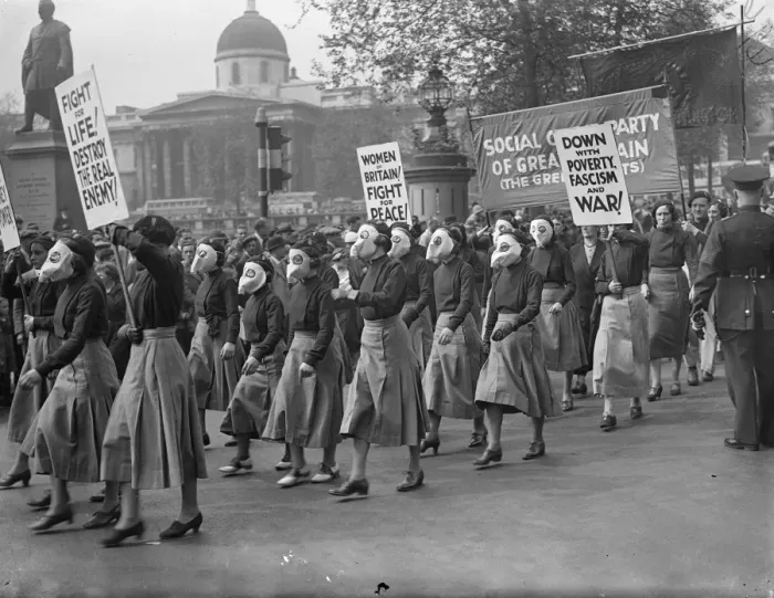 Framed Print : Masked women lead demonstrators in Trafalgar Square peace meeting. Led by women