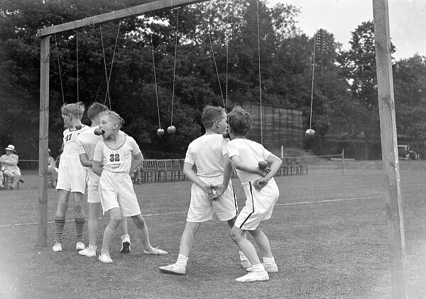 Merton Court sports day in Sidcup, Kent. Boys bobbing for apples. 1934