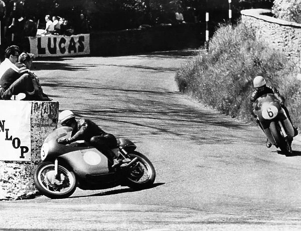 Mike Hailwood leads Rhodesias Gary Hocking as they go into the last lap in the Junior