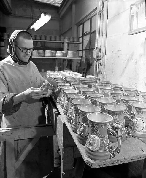 Monk makes Coronation monks. Brother Thomas inspecting completed coronation mugs