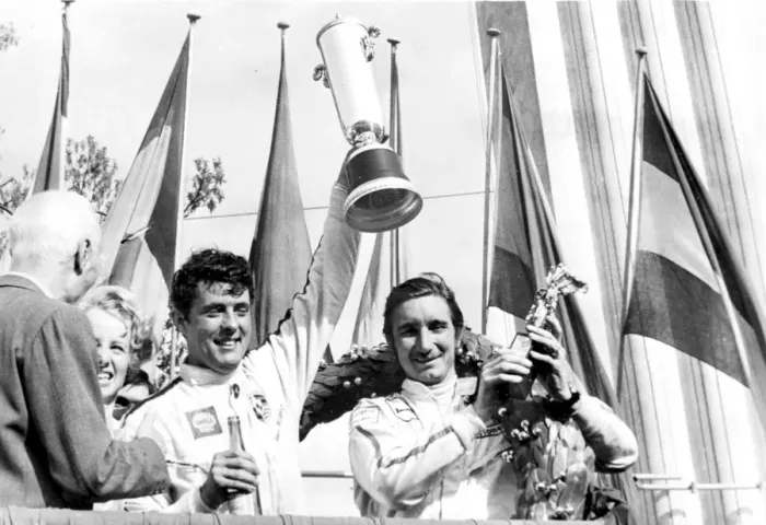 Framed Print : Monza, Italy: Brian Redman and Jo Siffert hold aloft their trophies after winning the 1, 000 KMS
