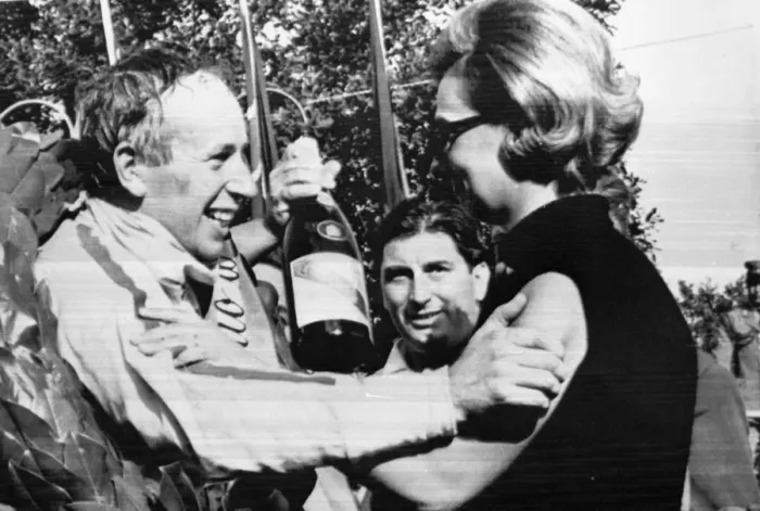 Framed Print : Monza Italy John Surtees is congratulated by Mrs Margherita Bandini widow of Lorenzo Bandini