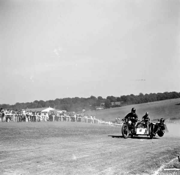 Motorcycle racing at Brands Hatch, Kent. Two sidecar motorbikes take a corner. 1936