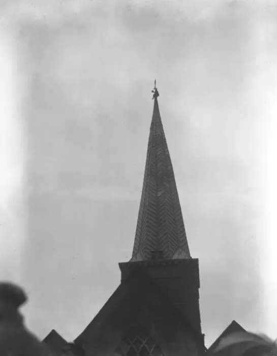 Framed Print : Mr Ager, the steeplejack, on top of the spire of Godalming church, retrieves a