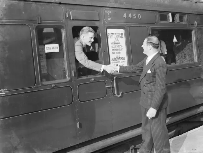 Framed Print : Mr David Behar shakes the hand of a passengers on the train for the Dartford Framed Print : Mr David Behar shakes the hand of a passengers on the train for the Dartford