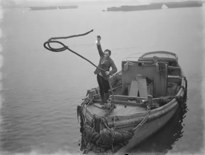 Framed Print : Mr Frank Clark MP tossing the lines to the quay side to tie up the boat. 1936
