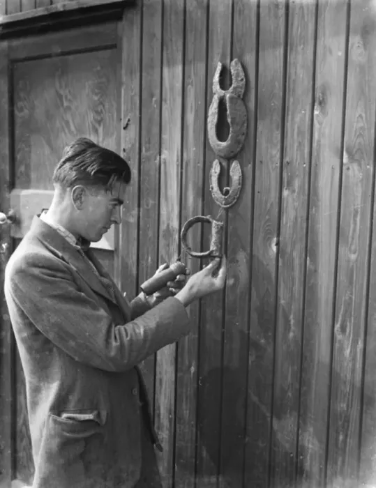 Framed Print : Mr Greenfield examines horseshoes and stirrups found at the excavation site of a Framed Print : Mr Greenfield examines horseshoes and stirrups found at the excavation site of a