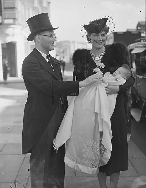 Mr and Mrs C G F Pritchett and their infant son after the babys christening at