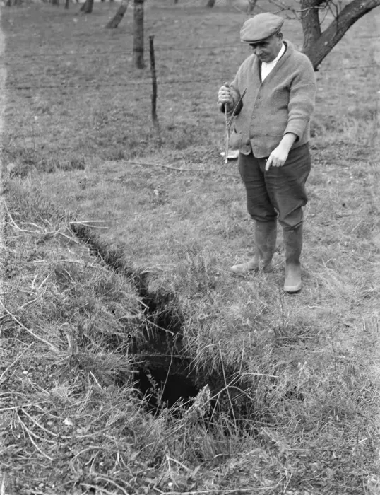 Framed Print : Mr Searles using a water diviner, points to where he believes water is available Framed Print : Mr Searles using a water diviner, points to where he believes water is available