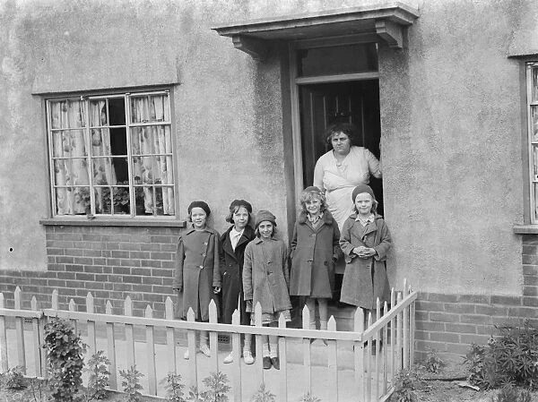 Mrs W E Wakefield with her daughters at the front of their home in Gravesend, Kent