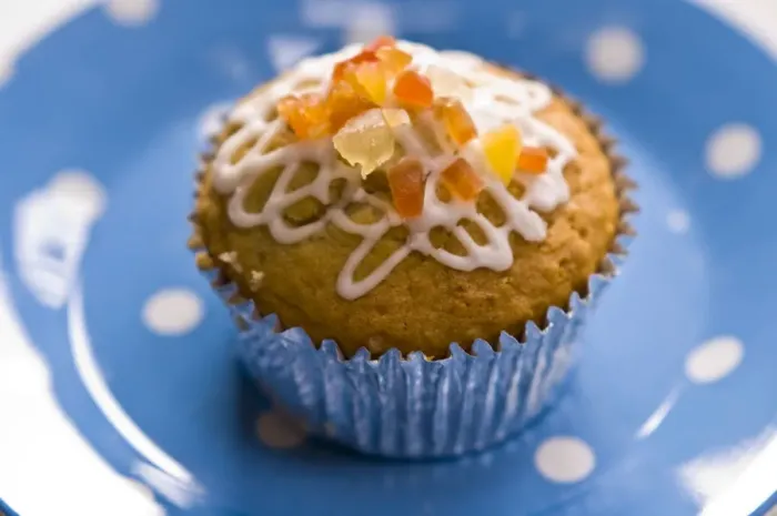 Framed Print : Muffin decorated with squiggly icing and candied peel on spotted blue plate credit Framed Print : Muffin decorated with squiggly icing and candied peel on spotted blue plate credit