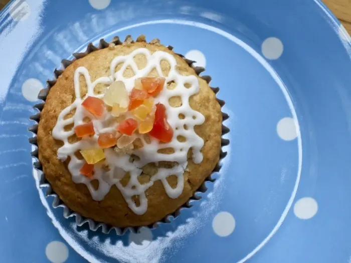 Framed Print : Muffin decorated with squiggly icing and candied peel on spotted blue plate credit Framed Print : Muffin decorated with squiggly icing and candied peel on spotted blue plate credit
