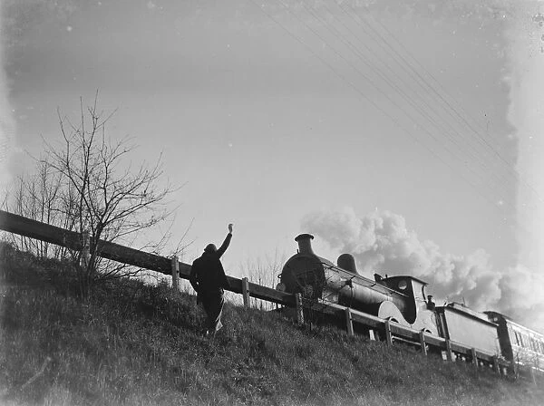 Muriel Haken waves to a passing train from a railway embankment. 1939
