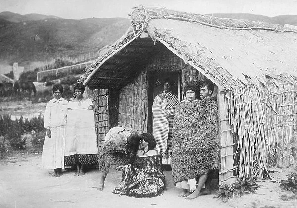 New Zealand. A typical Maori home. The two figures in the centre of the group