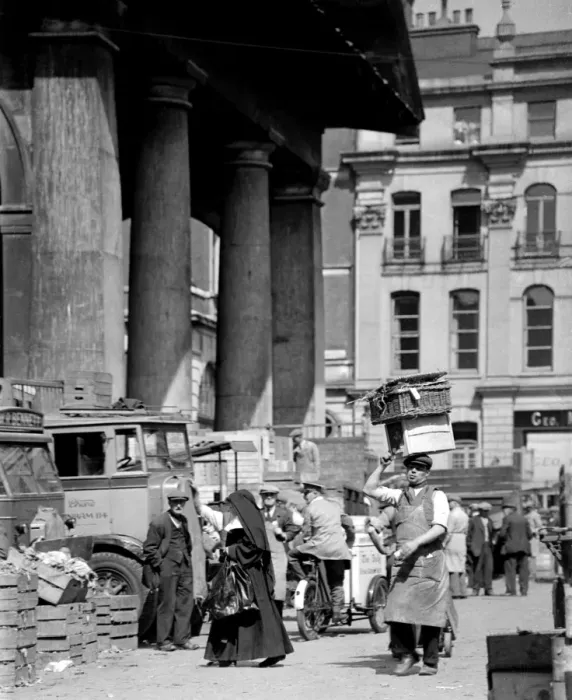 Framed Print : A nun picks her way through the busy flower, fruit and vegetable market, past all Framed Print : A nun picks her way through the busy flower, fruit and vegetable market, past all