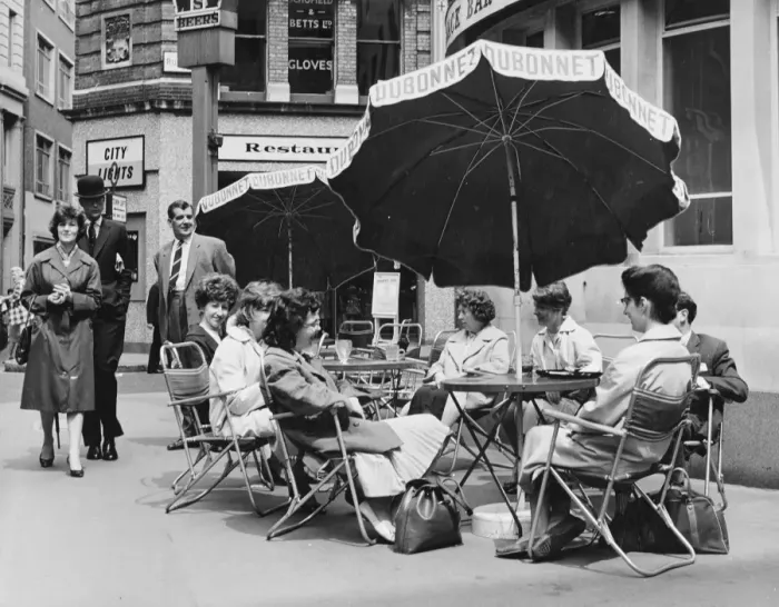Framed Print : Office girls take their lunch break al fresco in a continental style table and umbrella Framed Print : Office girls take their lunch break al fresco in a continental style table and umbrella