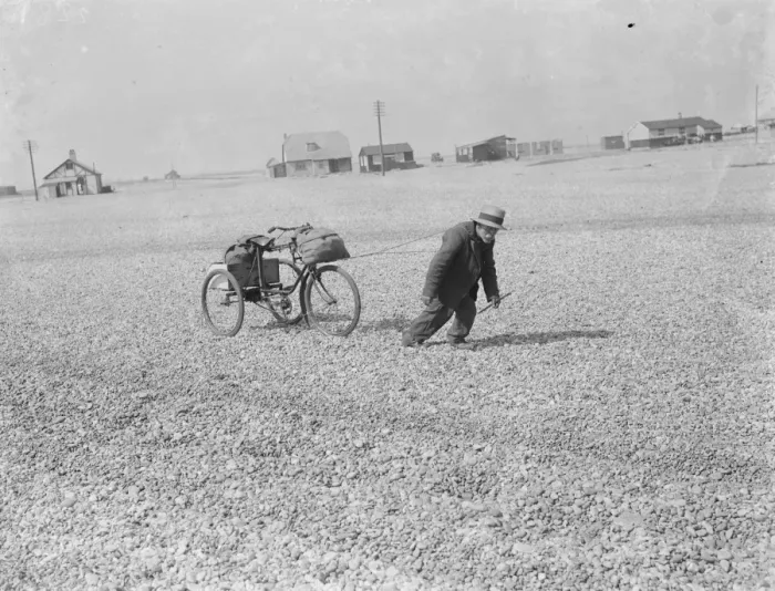 Framed Print : An old man pulling his tricycle along the shingle beach at Dungeness in Kent with Framed Print : An old man pulling his tricycle along the shingle beach at Dungeness in Kent with