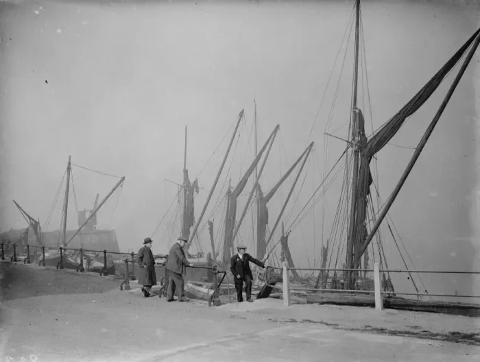 Framed Print : Old men on the riverside by the moored Thames sailing barges at Northfleet, Kent