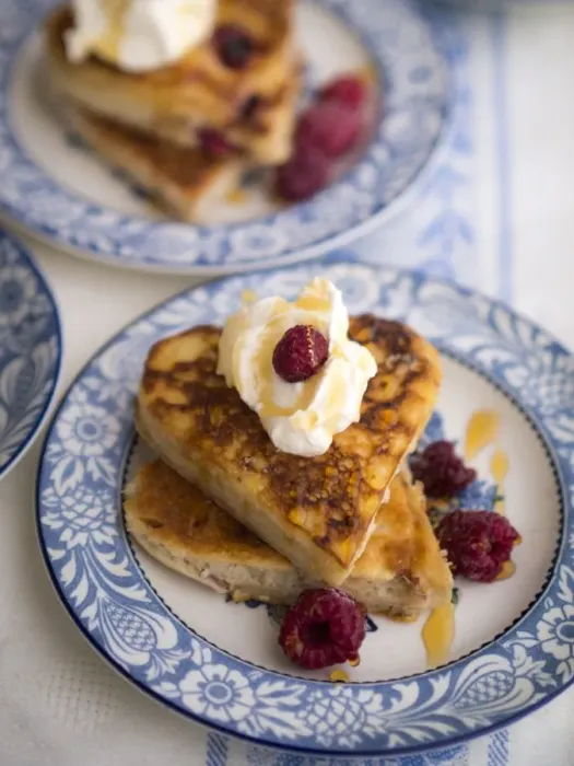 Framed Print : Pancakes made in heart shaped cutters served with whipped cream, raspberries