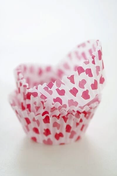 Paper cases for making muffins and fairy cakes - decorated with small red hearts credit