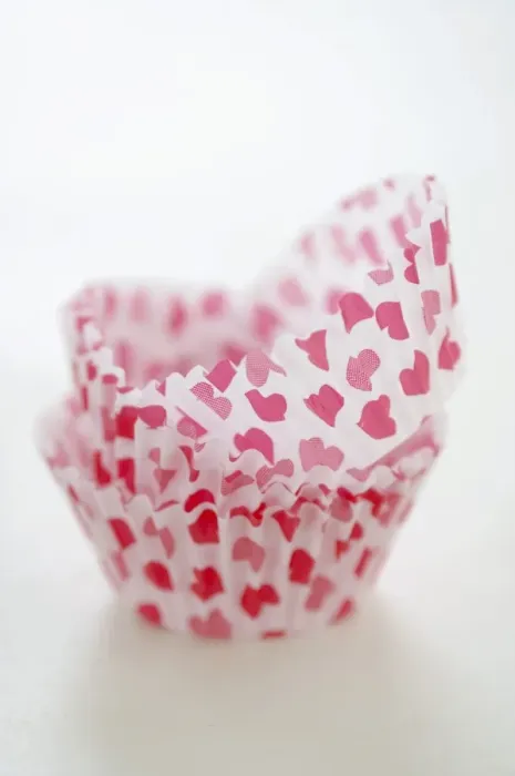 Framed Print : Paper cases for making muffins and fairy cakes - decorated with small red hearts credit