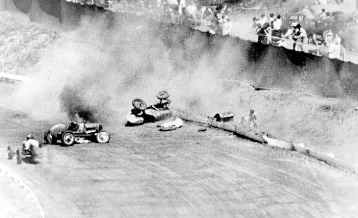 Framed Print : Phil Lacatiers driver car blazing on the track with Lacatier lies prone beside Framed Print : Phil Lacatiers driver car blazing on the track with Lacatier lies prone beside