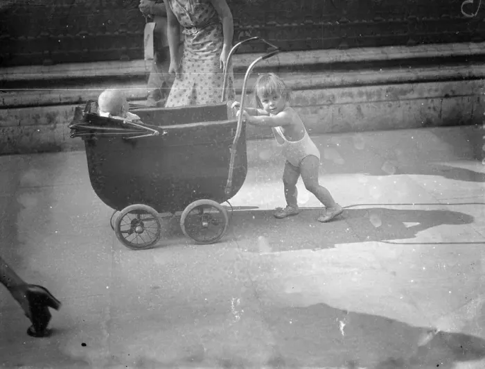 Framed Print : Piccadilly heat wave parade. In the briefest of bathing costumes this little girl Framed Print : Piccadilly heat wave parade. In the briefest of bathing costumes this little girl