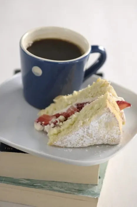 Framed Print : A piece of strawberry sponge cake on a white plate with a small blue and white spotted Framed Print : A piece of strawberry sponge cake on a white plate with a small blue and white spotted