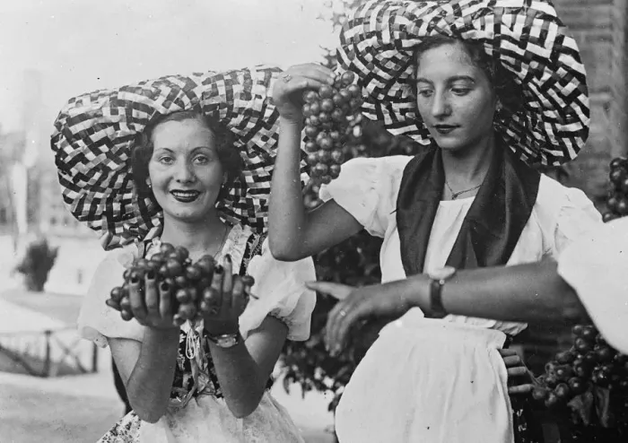 Framed Print : Two pretty Italian girls in peasant costume and broad brimmed hats offer bunches Framed Print : Two pretty Italian girls in peasant costume and broad brimmed hats offer bunches