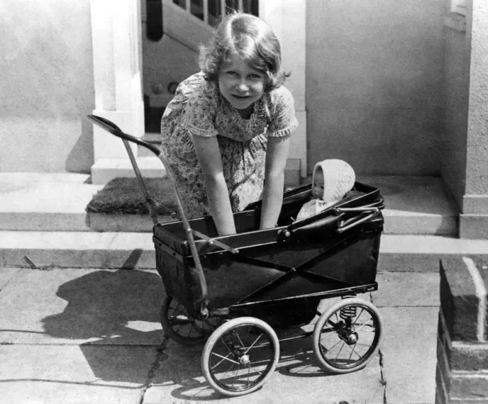 Framed Print : Princess Elizabeth playing with a dolls pram at the little house given to her