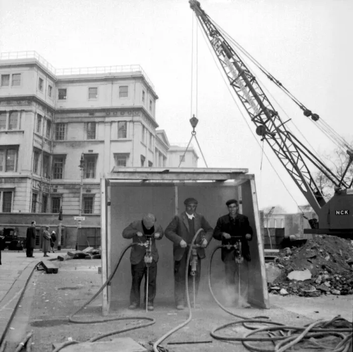 Framed Print : A purpose built shelter to protect from sound. Workmen break up the road surface outside St Framed Print : A purpose built shelter to protect from sound. Workmen break up the road surface outside St