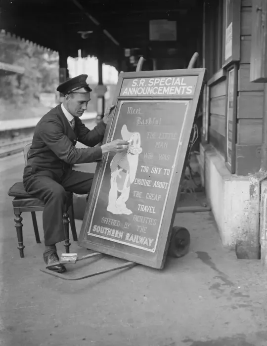 Framed Print : Railway porter sign writer Mr E A Burgar. 1938