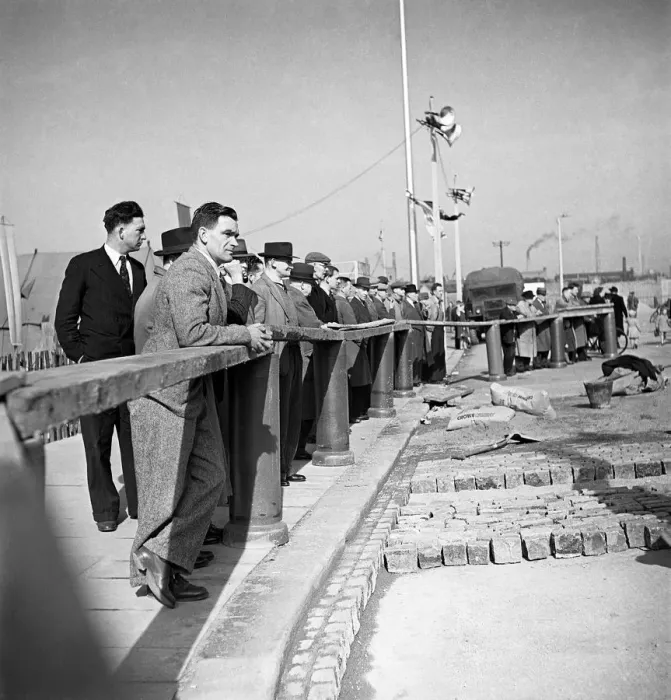 Framed Print : The rebuilding of Coventry City, England Citizens watch men at work, relaying