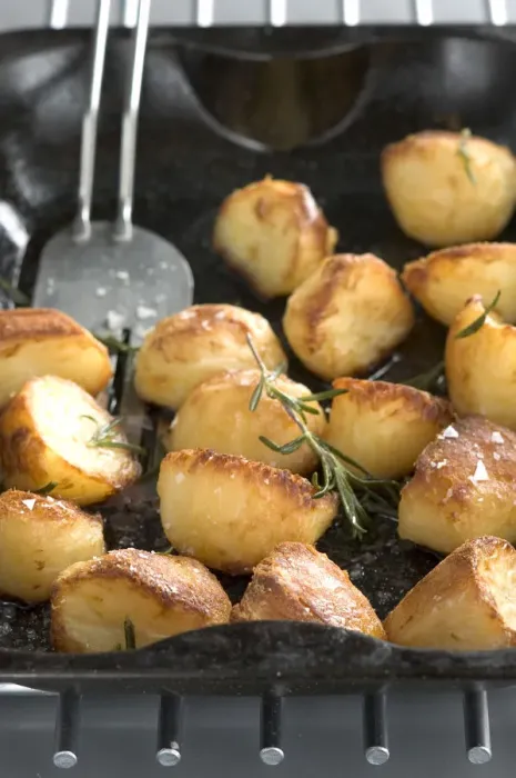 Framed Print : Roast potatoes in black roasting tin with salt and rosemary credit: Marie-Louise Framed Print : Roast potatoes in black roasting tin with salt and rosemary credit: Marie-Louise