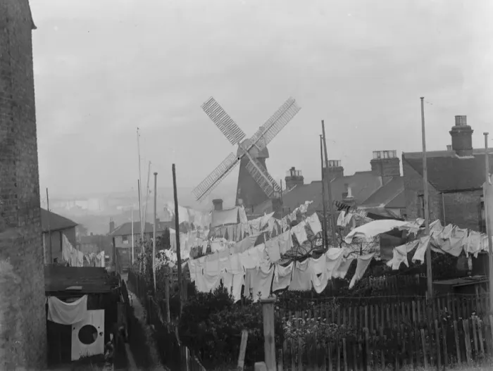 Framed Print : Rochester windmill in Kent, seen from behind the washing lines. 1936 Framed Print : Rochester windmill in Kent, seen from behind the washing lines. 1936