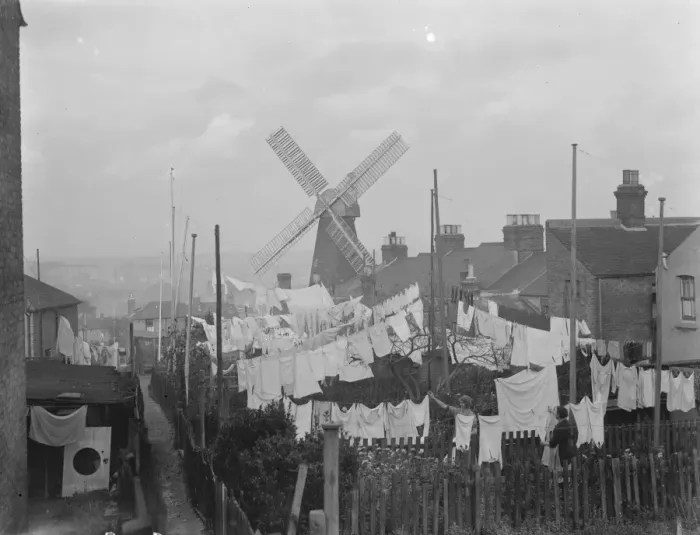 Framed Print : Rochester windmill in Kent, seen from behind the washing lines. 1936 Framed Print : Rochester windmill in Kent, seen from behind the washing lines. 1936