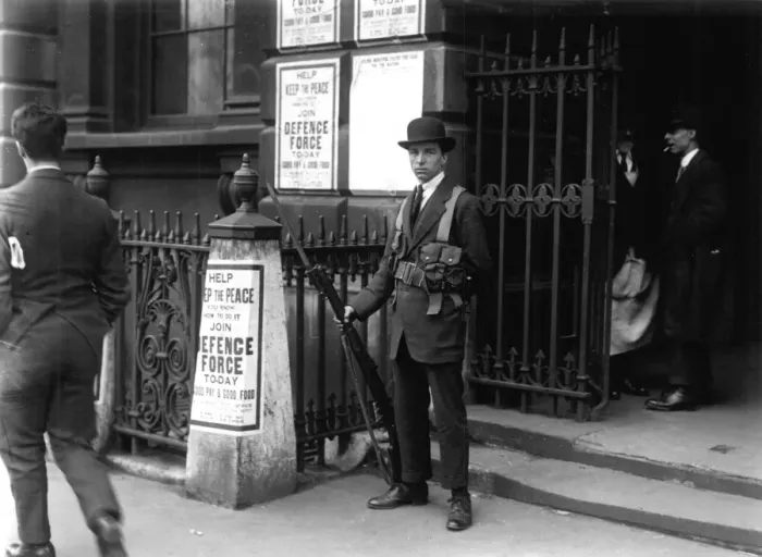 Framed Print : Royal Defence Force Sentry at Somerset House 1921 in front of posters offering good pay Framed Print : Royal Defence Force Sentry at Somerset House 1921 in front of posters offering good pay