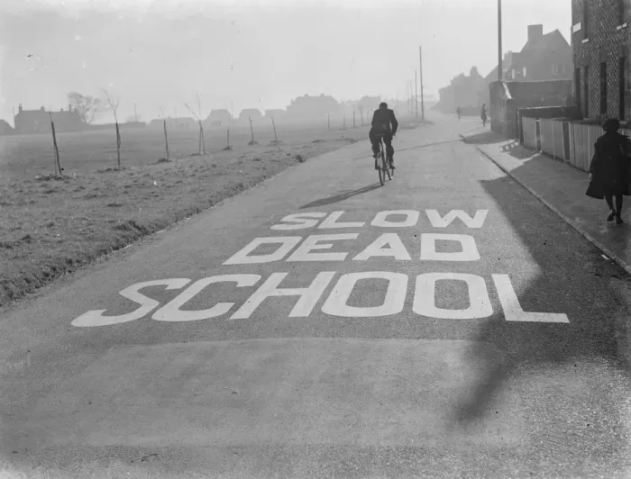 Framed Print : A school sign painted on the road warning road users they are approaching a school area Framed Print : A school sign painted on the road warning road users they are approaching a school area