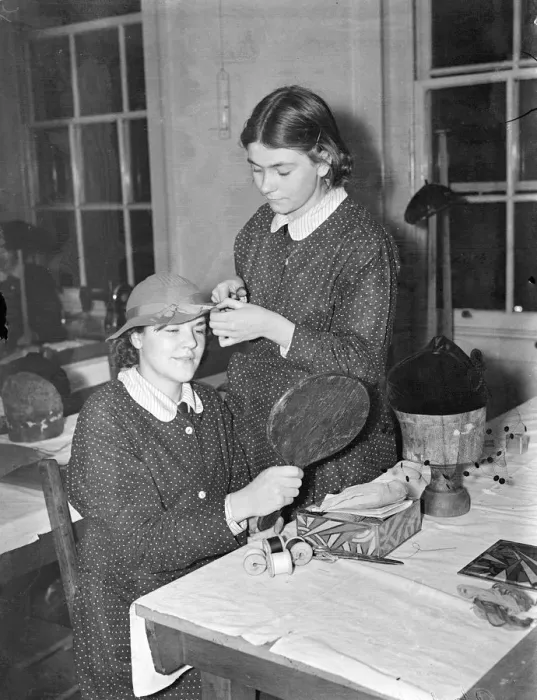 Framed Print : Schoolgirl dressmakers prepare for their own exhibition. Youthful dressmakers, milliners