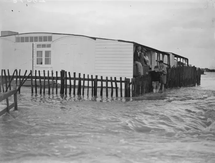 Framed Print : Sea defences broken by flood tide at Winchelsea, bungalows flooded and holidaymakers