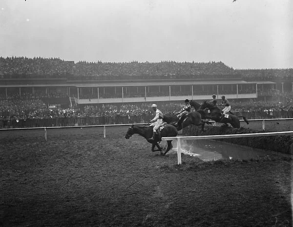 Sensational Grand National. Some of the field taking one of the difficult jumps