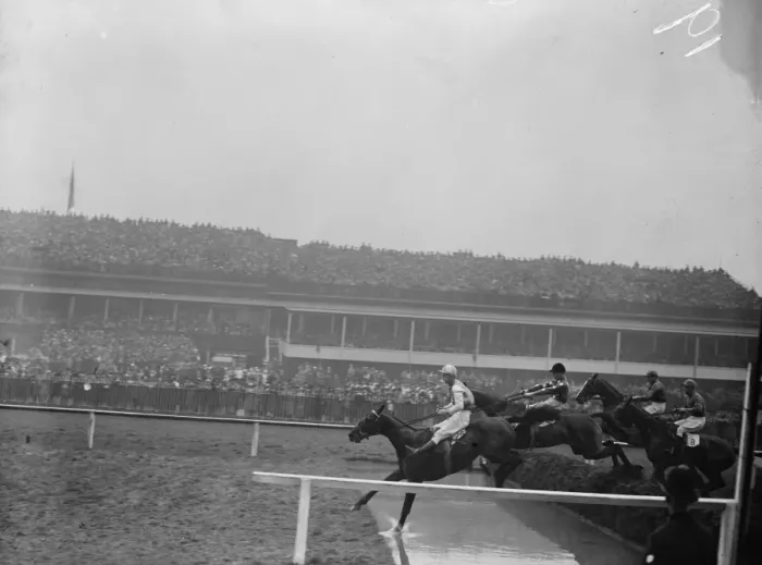Framed Print : Sensational Grand National. Four of the field taking the water jump in front of the Grand Stand