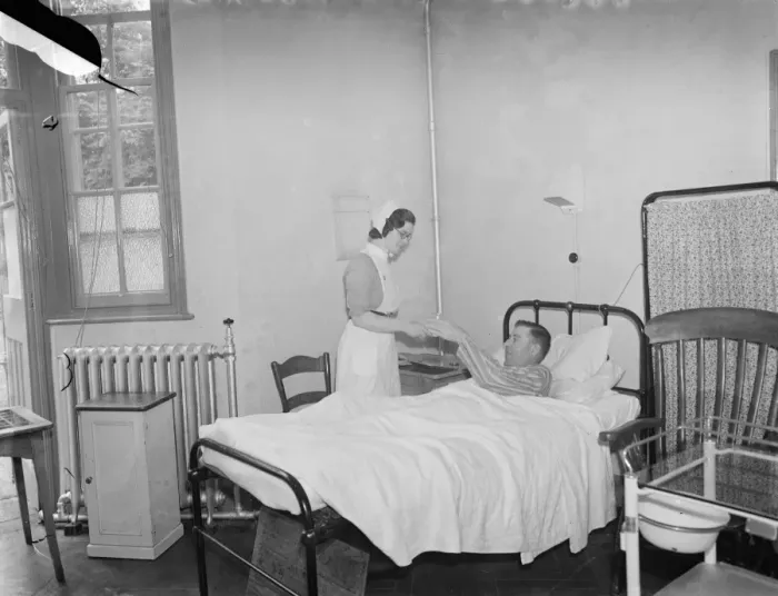 Framed Print : The Sidcup Cottage Hospital in Kent. A nurse tends to Mr Frank Ager, a patient Framed Print : The Sidcup Cottage Hospital in Kent. A nurse tends to Mr Frank Ager, a patient