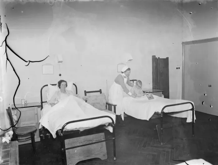 Framed Print : The Sidcup Cottage Hospital in Kent. A nurse tends to a patient in the womens ward Framed Print : The Sidcup Cottage Hospital in Kent. A nurse tends to a patient in the womens ward