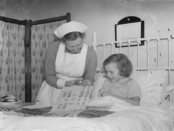 Framed Print : The Sidcup Cottage Hospital in Kent. Nurse Wendy Saunders is helping a little Framed Print : The Sidcup Cottage Hospital in Kent. Nurse Wendy Saunders is helping a little