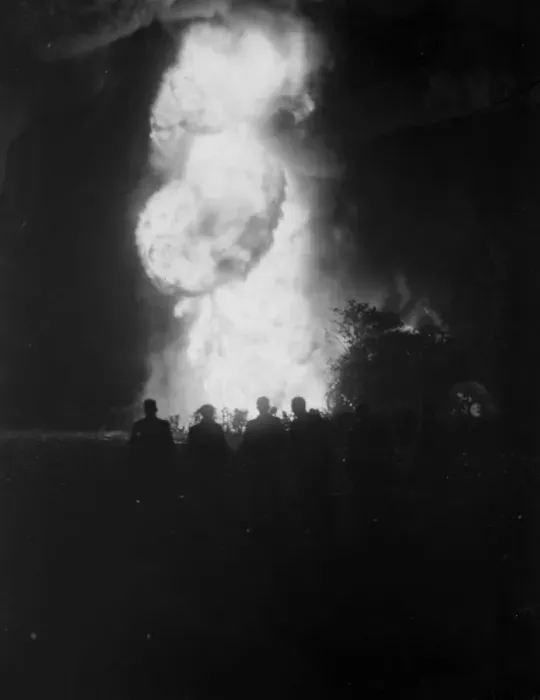 Framed Print : The silhouetted figures of men can be seen against the flames and smoke from Framed Print : The silhouetted figures of men can be seen against the flames and smoke from