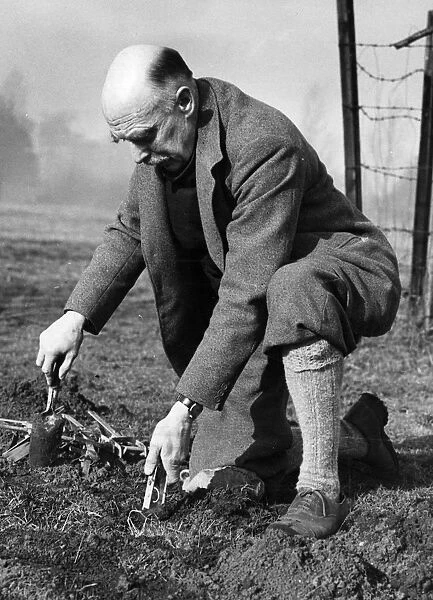 Sir Stephen Tallens seen here setting a mole trap even though he is a Knight Commander