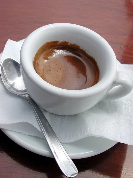 Small cup of strong espresso coffee, served in outdoor cafe in Amalfi, Italy credit