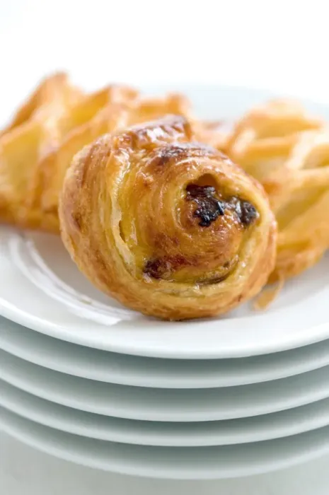 Framed Print : Small danish pastries on stack of white plates credit: Marie-Louise Avery  /  thePictureKitchen