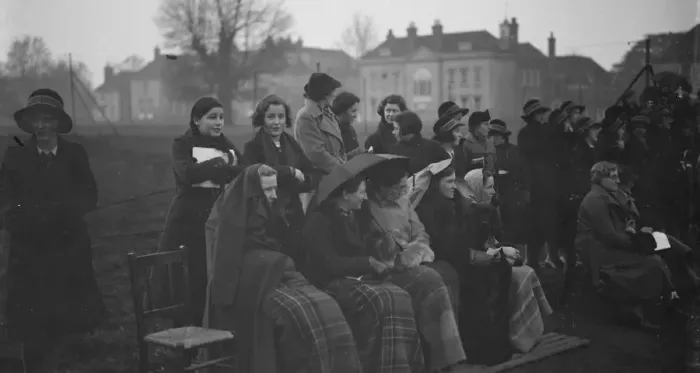 Framed Print : Spectators try to keep warm and dry during the Lacrosse match - East versus West Framed Print : Spectators try to keep warm and dry during the Lacrosse match - East versus West